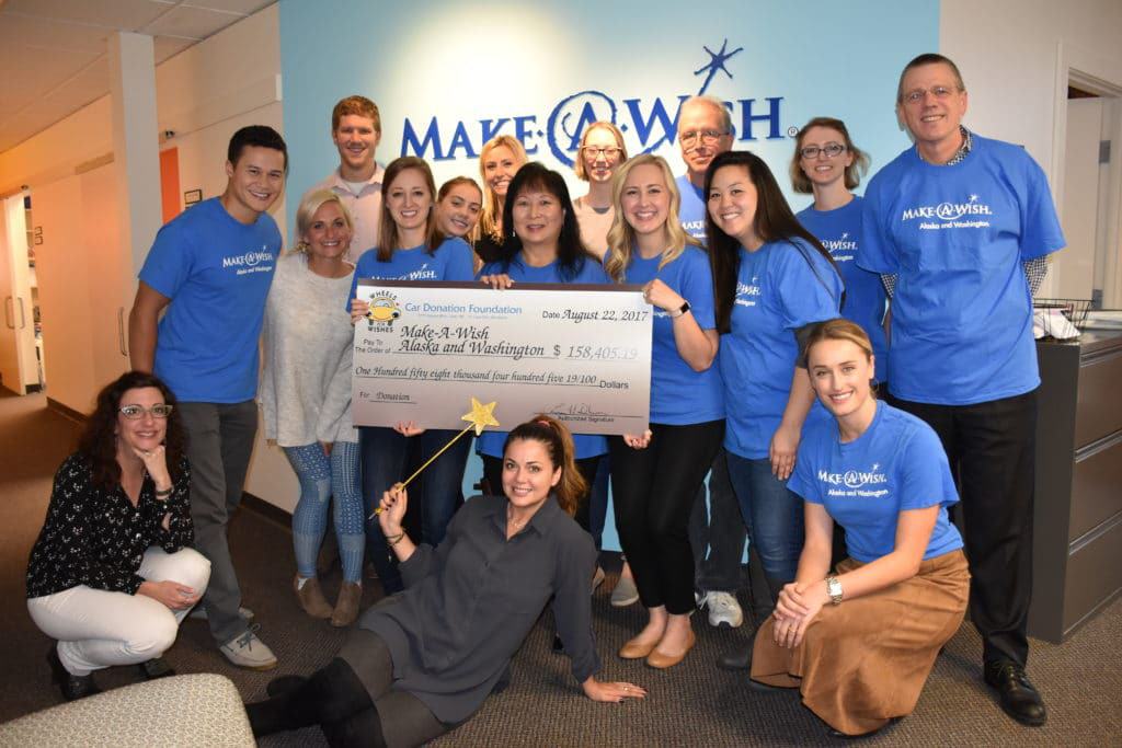 Make-A-Wish Alaska and Washington staff members with the Wheels for Wishes check