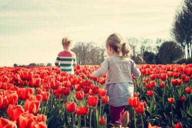 Girl running through flowers 