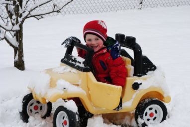 boy in toy car