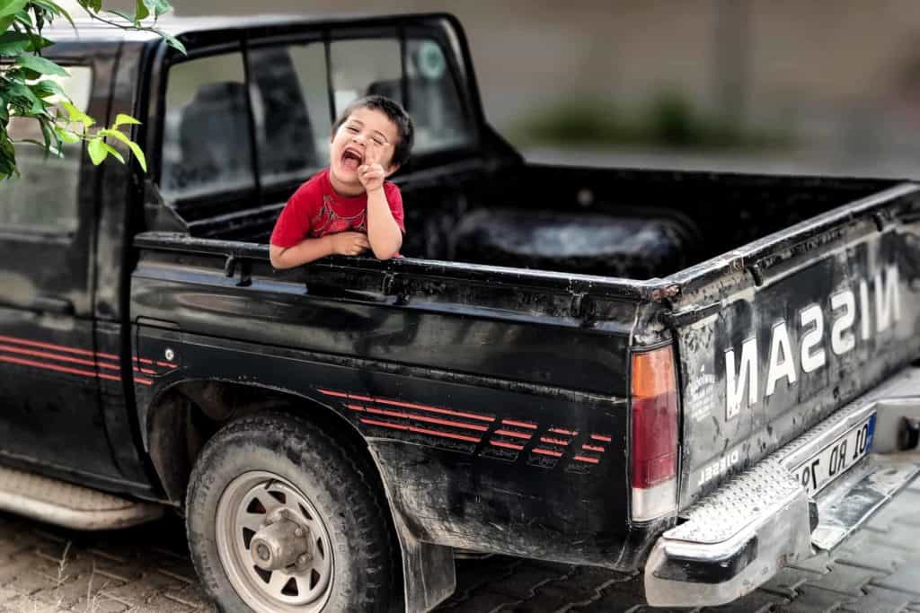 Boy in back of truck