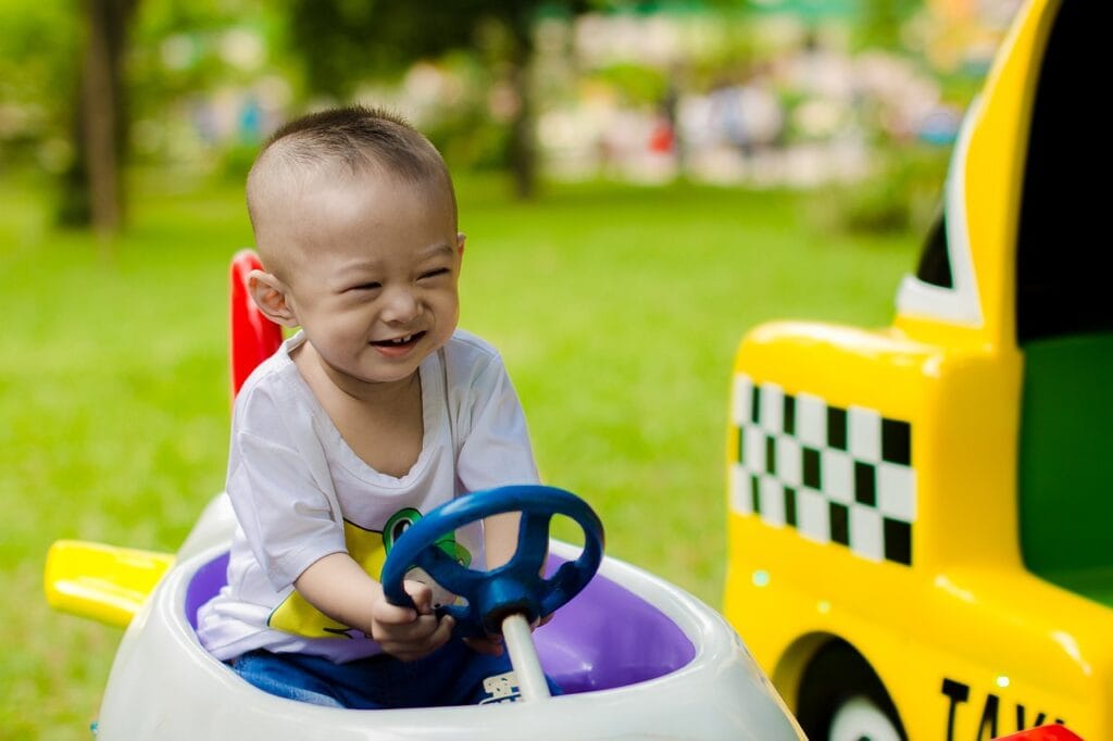 Kid playing in toy car