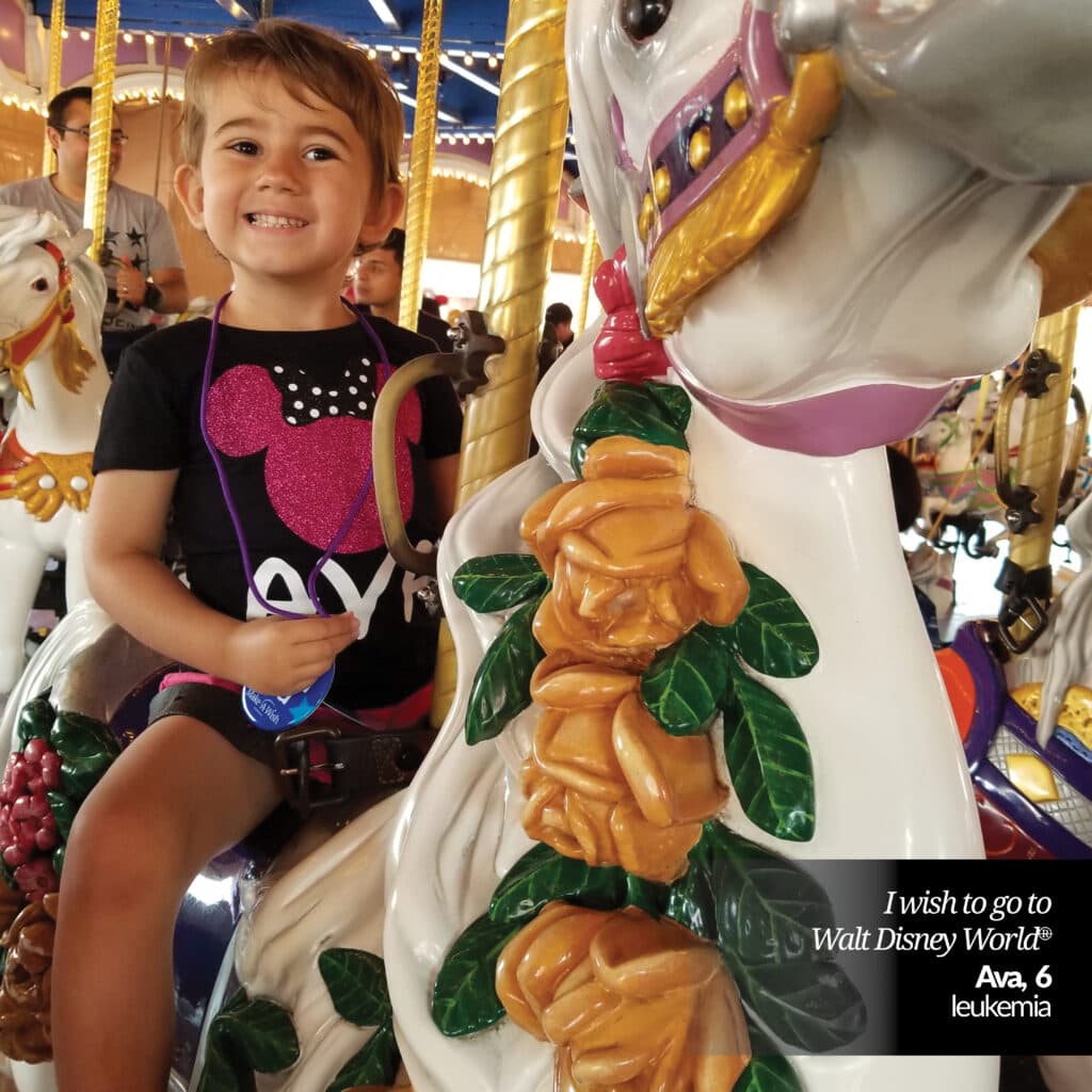 Make-A-Wish kid, Ava, on carousel at Disney World