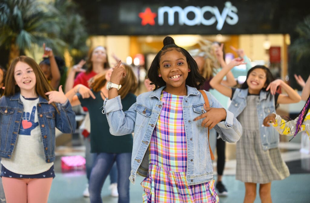 Make-A-Wish kid dancing in front of a Macy's