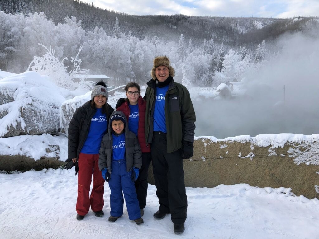 One of Michigan's Make-A-Wish families standing in front of a snowy landscape. 