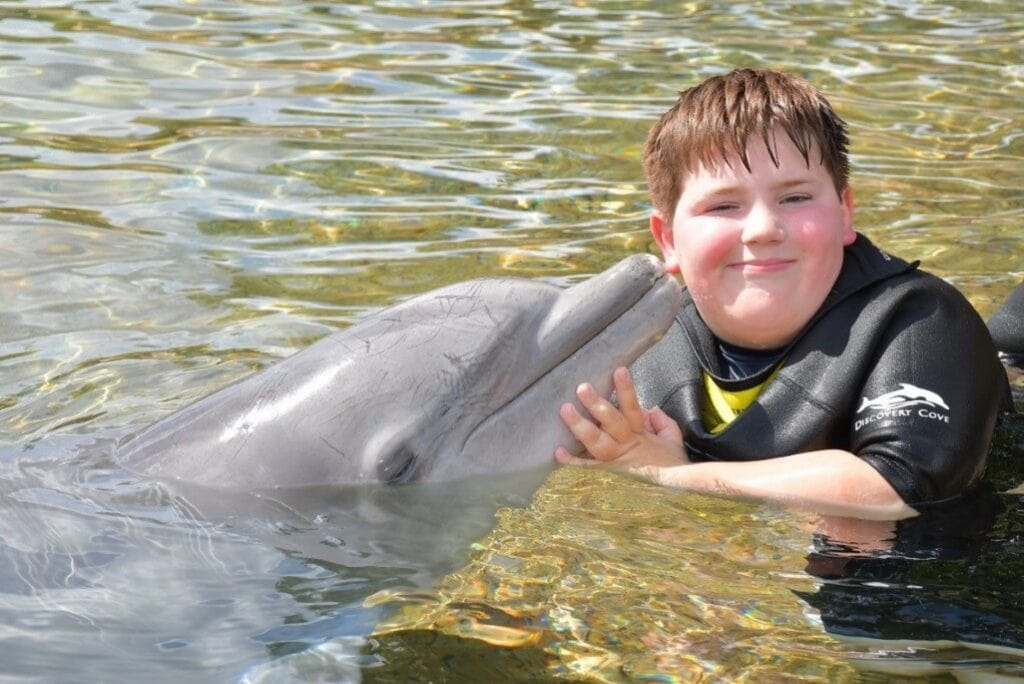 Make-A-Wish kid swimming with a dolphin