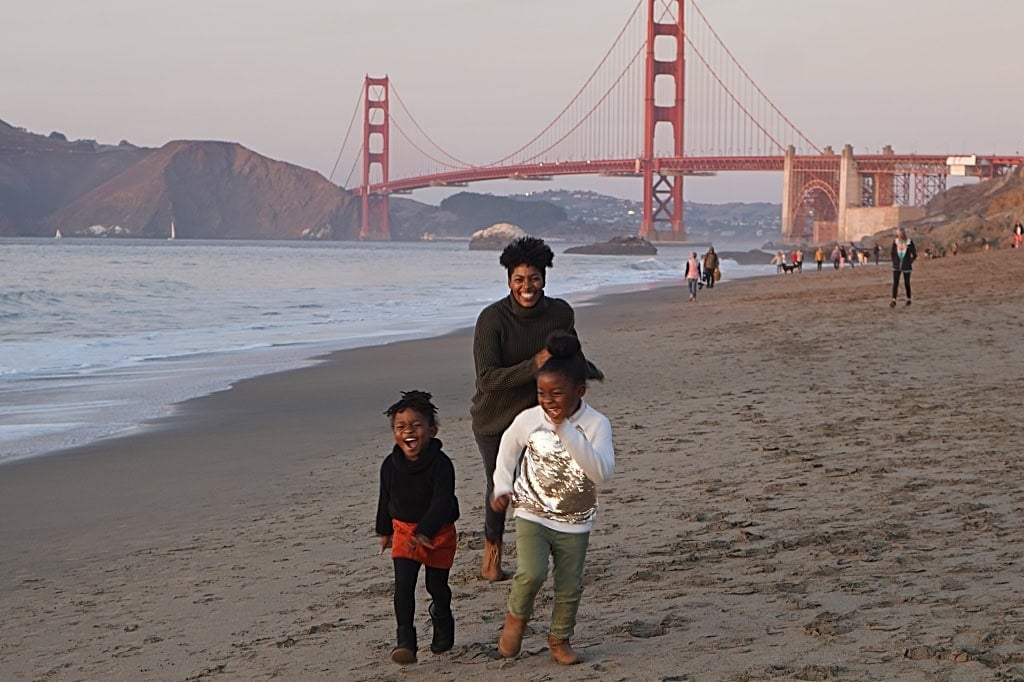 Happy family with Golden Gate Bridge in the background.