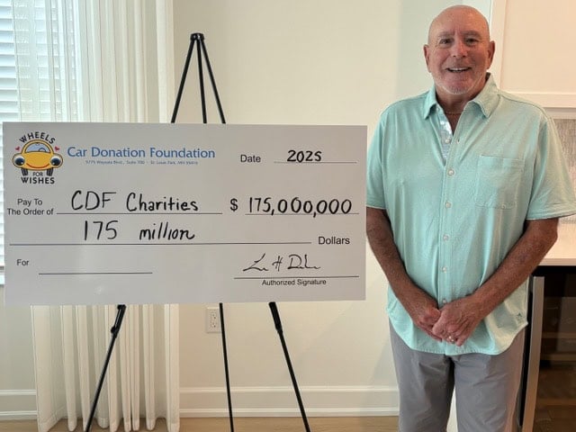 CDF's Loren Dorshow presenting $175 million big check to charities.