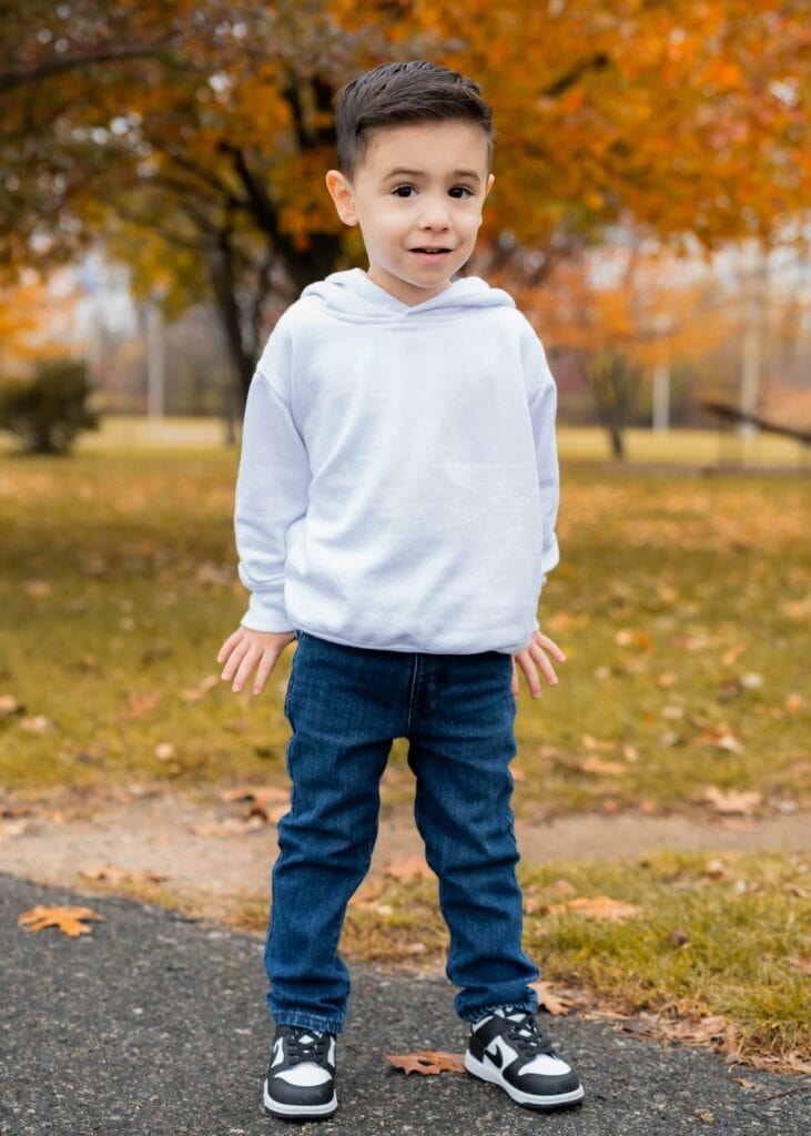 Kid standing in park in autumn in New Jersey
