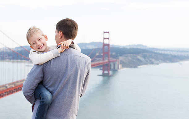Family of two enjoying time together and famous sightseeing in San Francisco - Golden Gate Bridge.