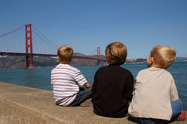 Boys looking at the Golden Gate Bridge in San Francisco.