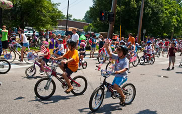 children in Hudson Valley riding their bikes on the street