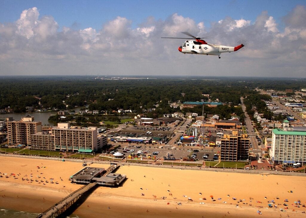 Helicopter flying over a coastal beach town