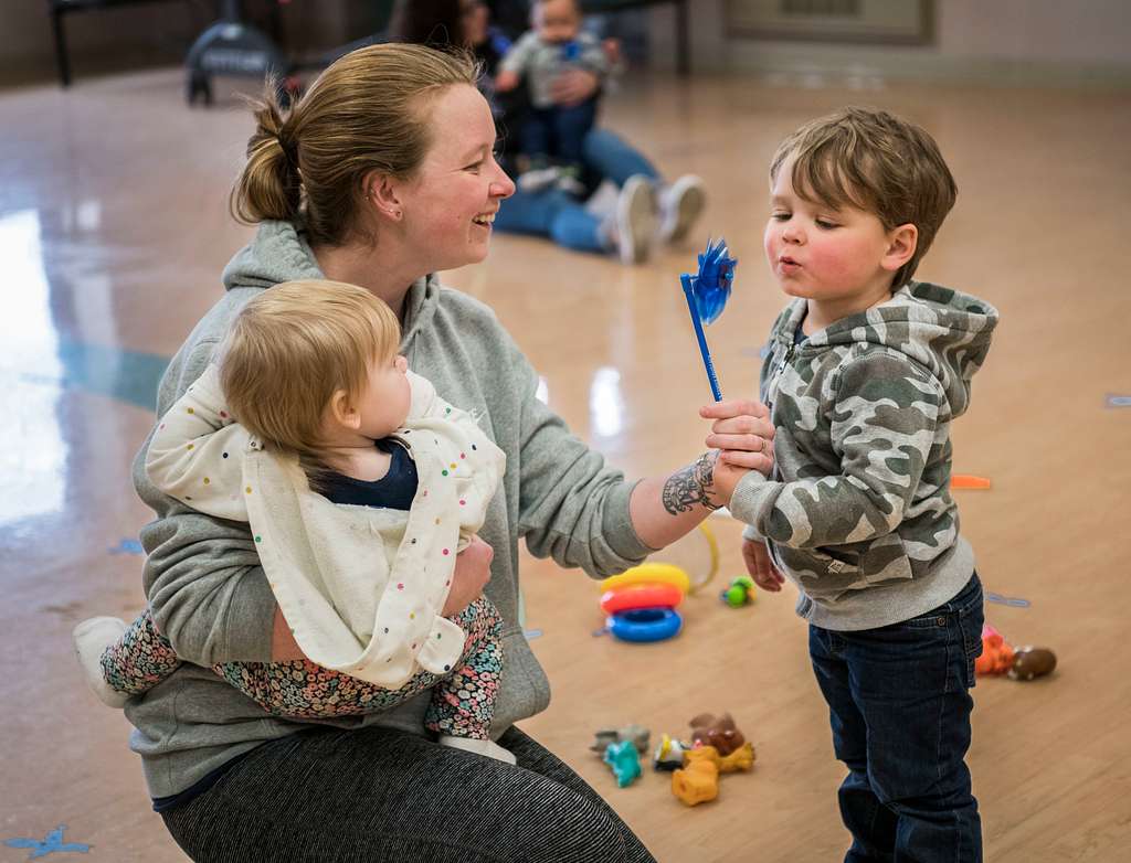 Mom with son and daughter, playing with pinwheel in Delaware