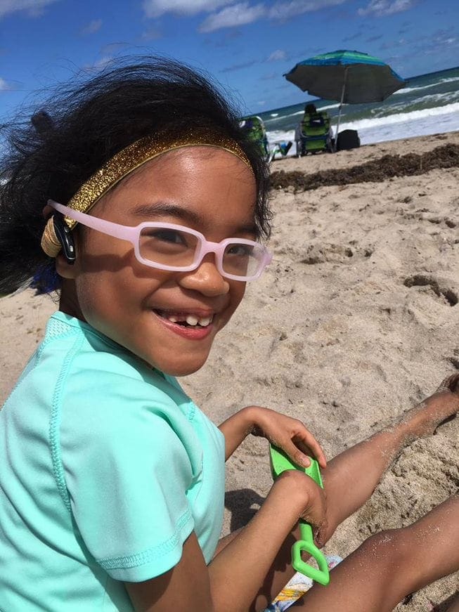 Smiling child on a sandy beach
