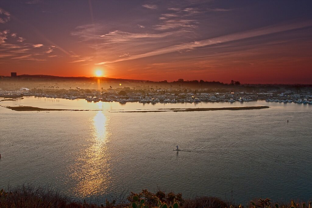 Sunset over a harbor with boats